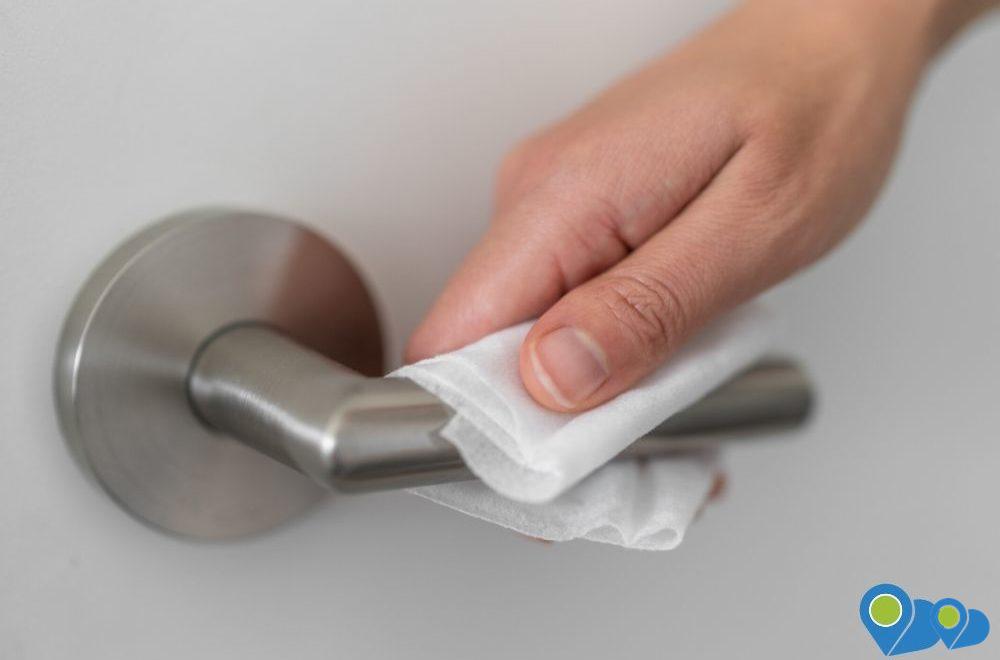 opening door knob using sanitizing towel as a preventive measure for coronavirus