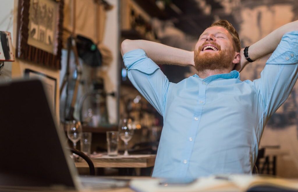 man leaning back with relieved smile