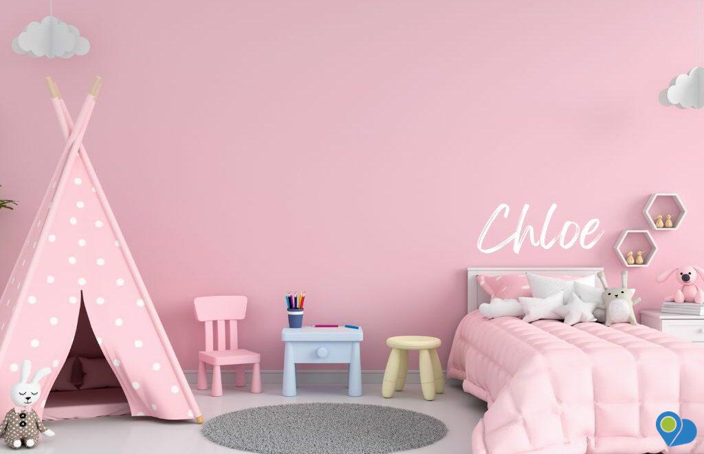Pink bedroom with the child's name stenciled on the wall