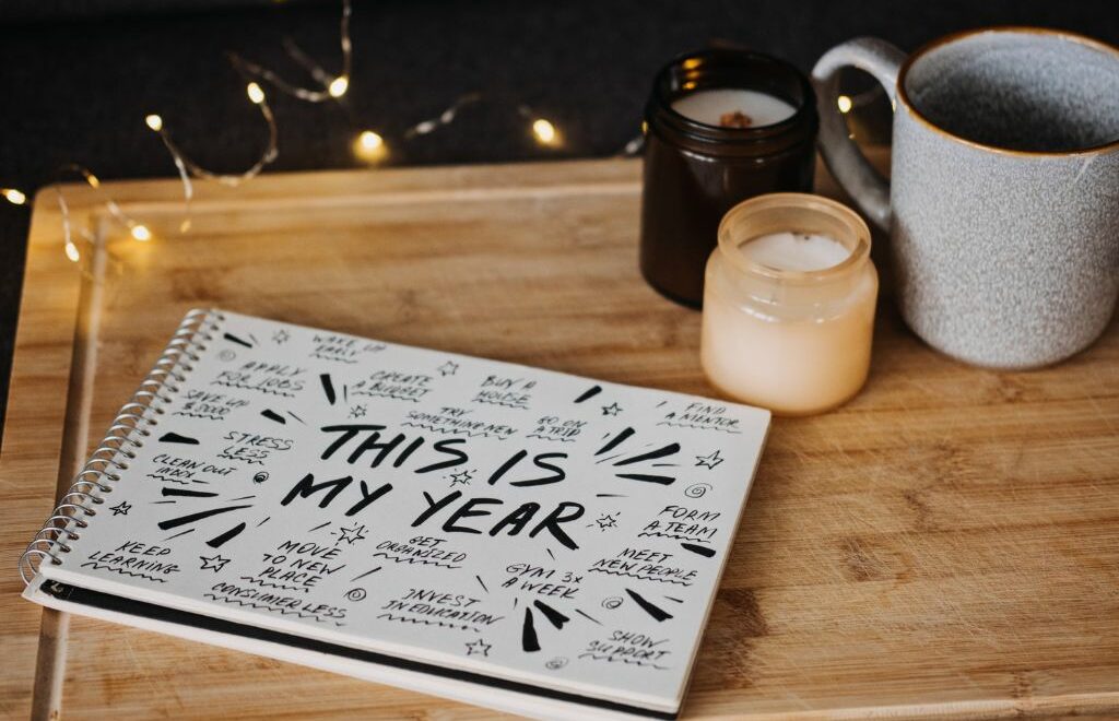 desk with candles and notpad with doodling "This is my year"