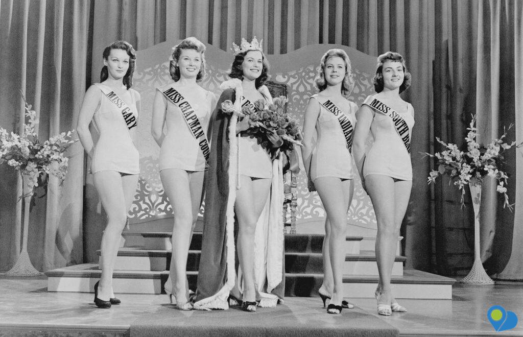 black and white photo of beauty pageant contestants on stage